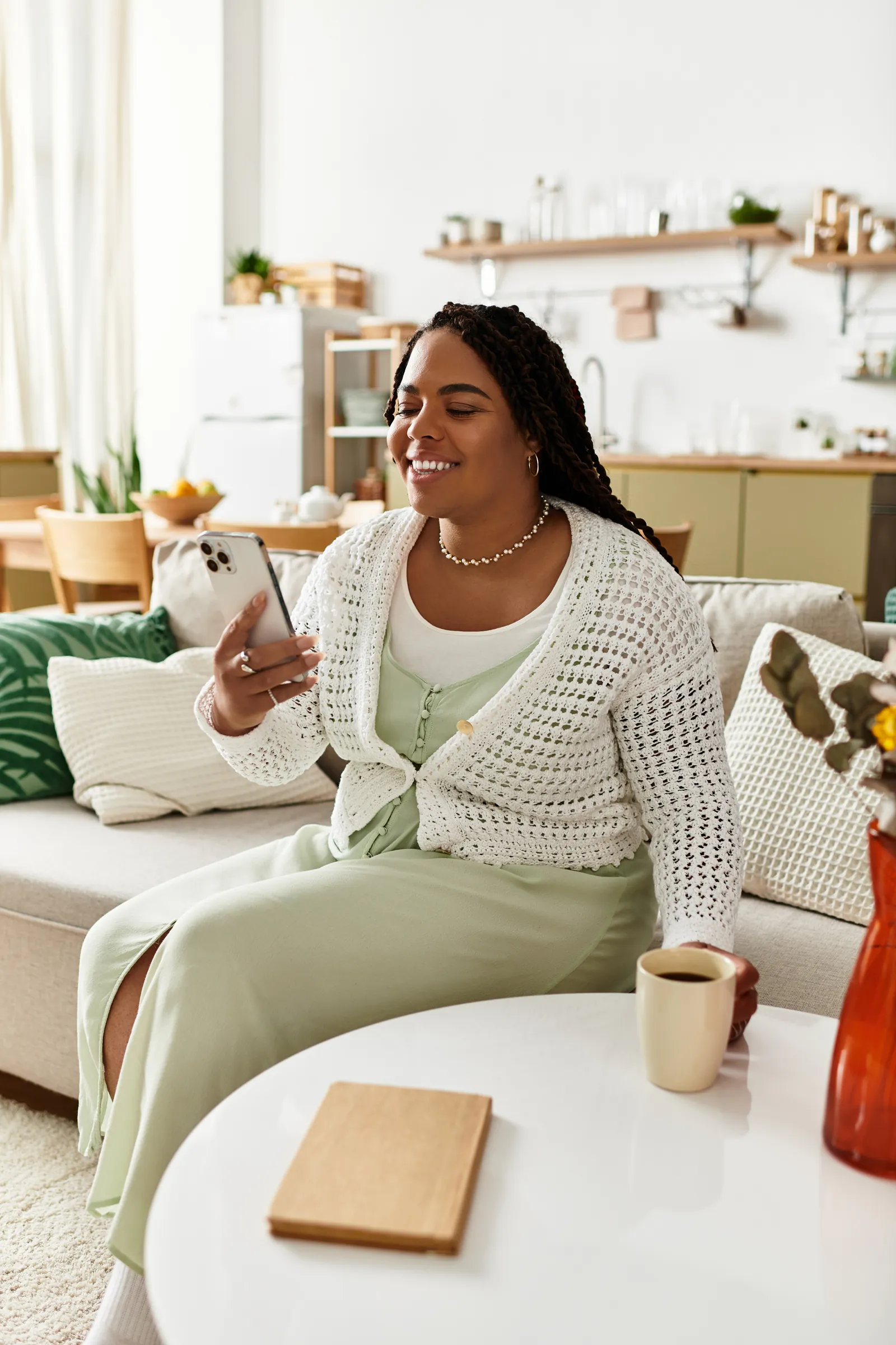 Smiling woman relaxing at home with her phone